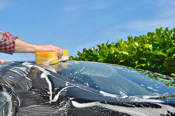 39494198 - car care man washing a car by hand using a sponge 39494198 - car care man washing a car by hand using a sponge